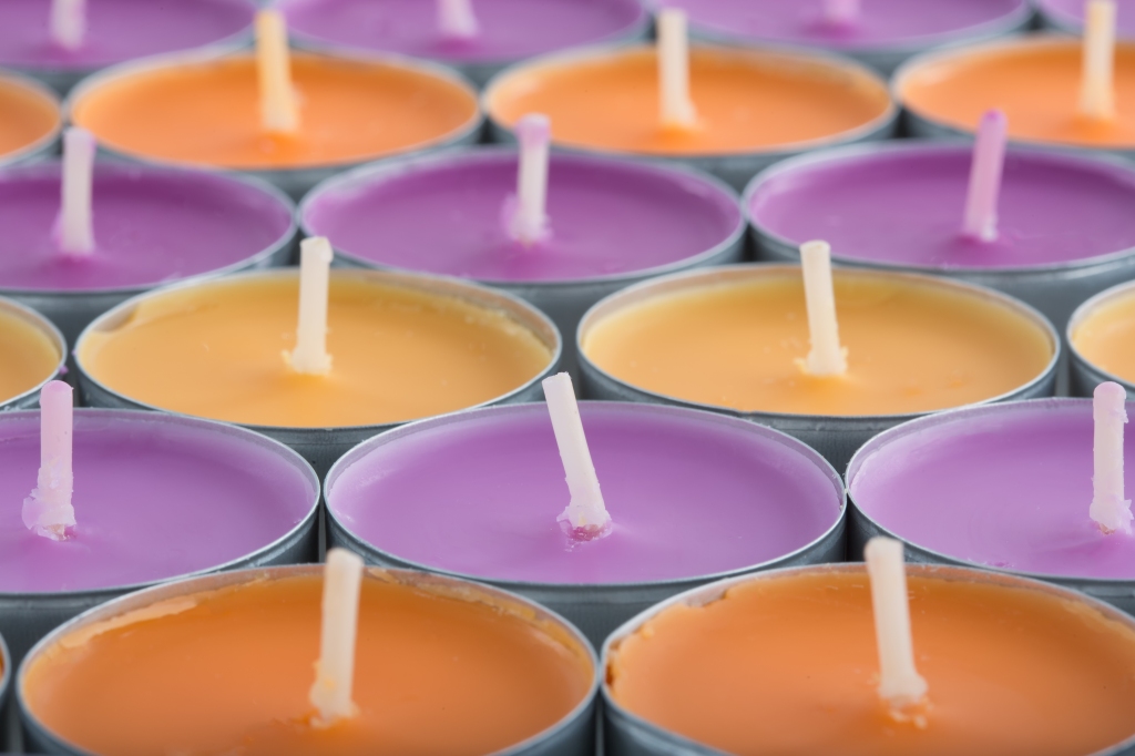 closeup of rows of purple and orange candles